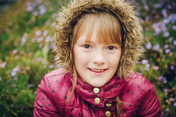 Close up image of pretty little girl wearing warm winter jacket with hood — Stock Photo, Image