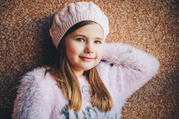 Close up portrait of pretty little girl wearing pink beret and fluffy pullover, winter fashion for kids — Stock Photo, Image