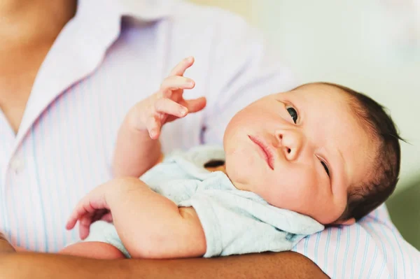 Adorable one day old baby holding by a parent — Stock Photo, Image