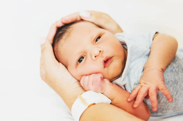 Adorable one day old baby holding by a parent — Stock Photo, Image