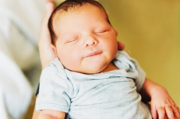 Adorable one day old baby holding by a parent — Stock Photo, Image