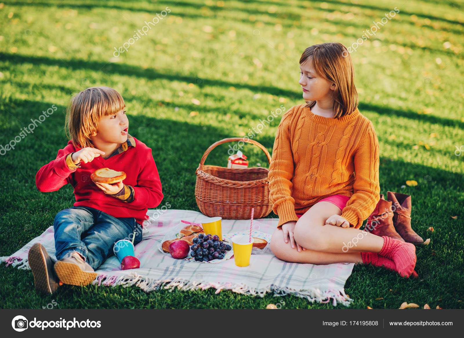 Kids eating snacks outside. Children resting in the park on a nice