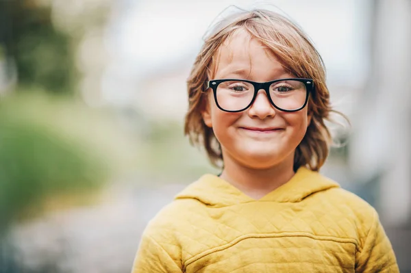 Retrato de cerca del adorable niño pequeño con anteojos y sudadera amarilla — Foto de Stock