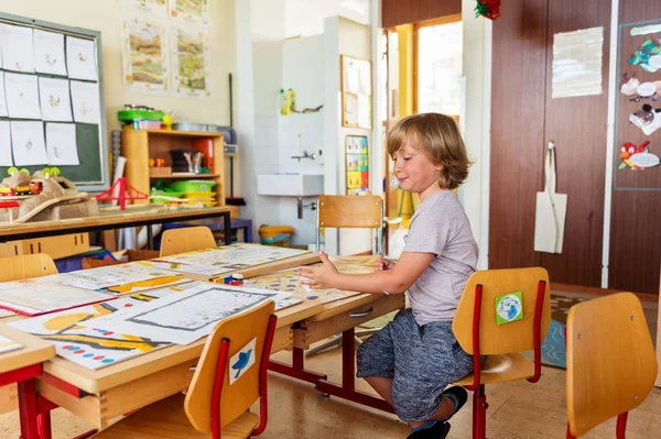 Cute little boy working in classroom, education, back to school concept — Stock Photo, Image