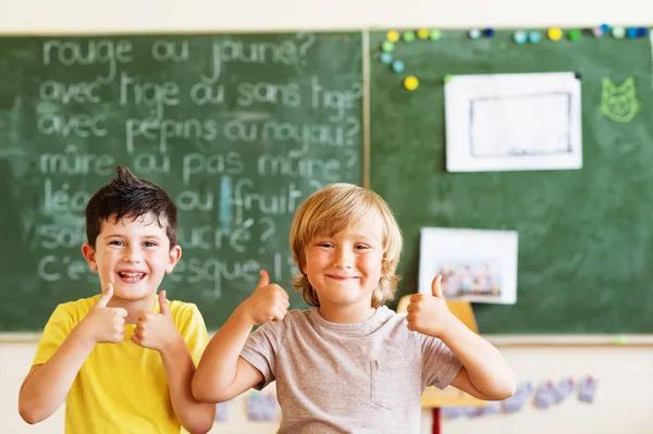 Gelukkige kinderen werken in de klas, grote duimen omhoog, onderwijs, terug naar school concept — Stockfoto