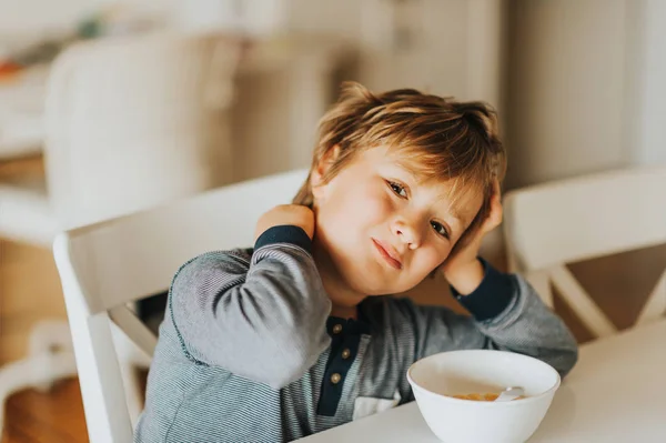 Søt Liten Gutt Som Spiser Korn Med Melk Til Frokost – stockfoto