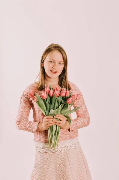 ピンクのチューリップを保持 トレーナーを着てかわいい Preteen 女の子のスタジオ画像 — ストック写真