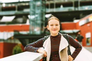 Outdoor portrait of young teenage girl with backpack