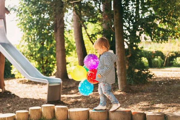 面白いです子供の女の子遊び場でカラフルな風船で遊ぶ — ストック写真