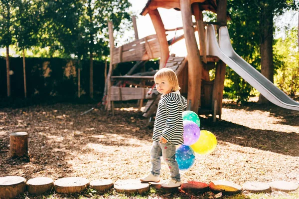 面白いです子供の女の子遊び場でカラフルな風船で遊ぶ — ストック写真