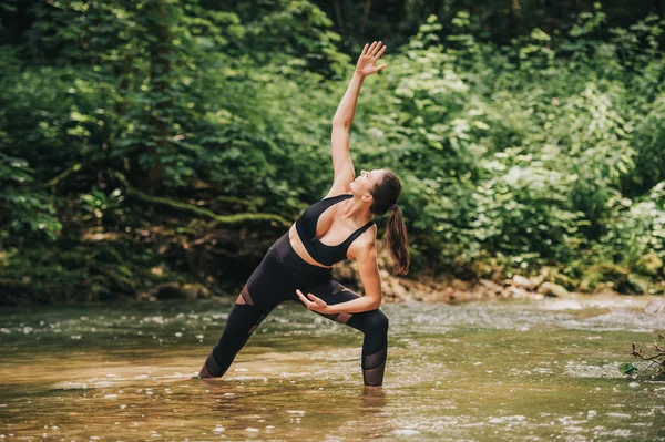 Young Fit Woman Practicing Yoga Standing River Wearing Black Leggings — ストック写真