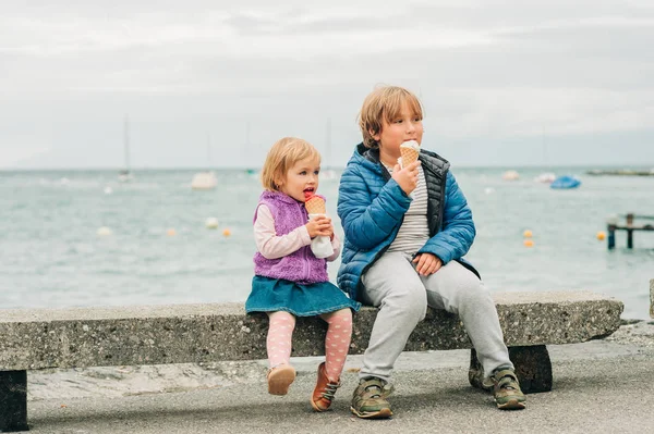 Двое Забавных Детей Едят Мороженое Озера Дождливый День — стоковое фото