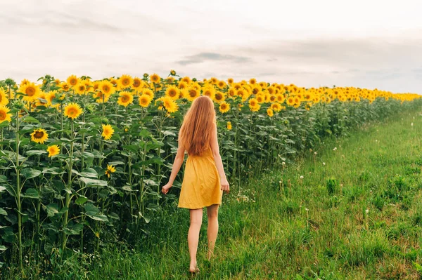 Young Girl Red Hair Walking Away Sunflower Field Wearing Yellow — Stock Photo, Image