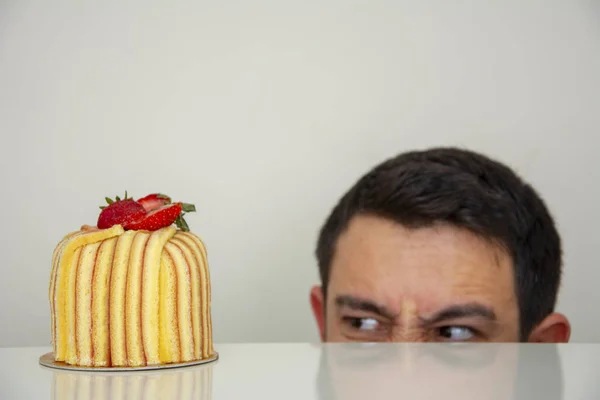 Man angry looking at cake