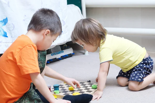 Hermano y hermana jugando juntos, hermanos juegan en casa en el ajedrez — Foto de Stock
