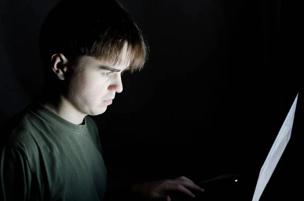 Homem no quarto escuro usando laptop, jovem trabalhando no computador, conceito de prevenção de detecção de fraude, programador sério codificação à noite, hacking, ideia de vício na Internet, fundo escuro isolado — Fotografia de Stock