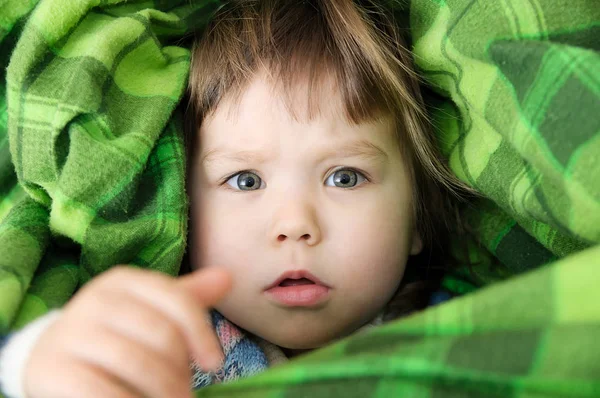 Child portrait in blanket pulling out hands — Stock Photo, Image