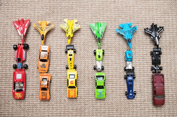 Toy cars collection on carpet.Sorted by color. Transportation, airplane, plane and helicopter toys for children, miniature models. Many cars for little boys. — Stock Photo, Image