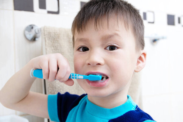 Boy brushing teeth, child dental care, oral hygiene concept, child portrait in bathroom with tooth brush,healthy lifestyle