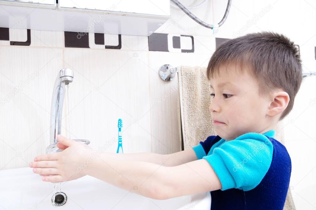 Boy washing hands, child personal health care, hygiene concept, kid washing hand in wash basin in bathroom, healthy lifestyle