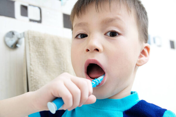 Child brushing teeth, boy dental care, oral hygiene concept, child in bathroom with tooth brush,healthy lifestyle