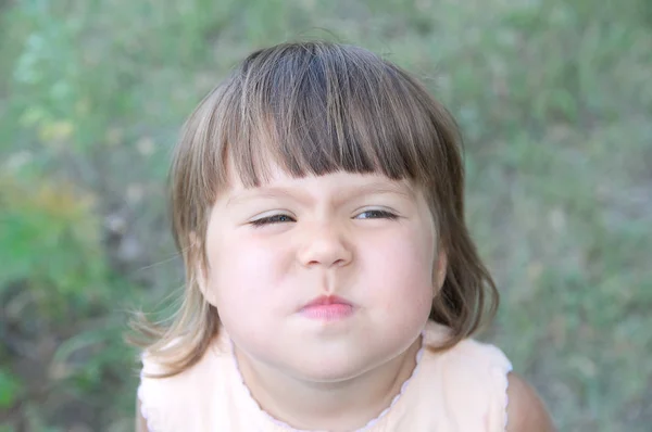 Little girl wrinkle nose making funny face portrait from above — Stock Photo, Image