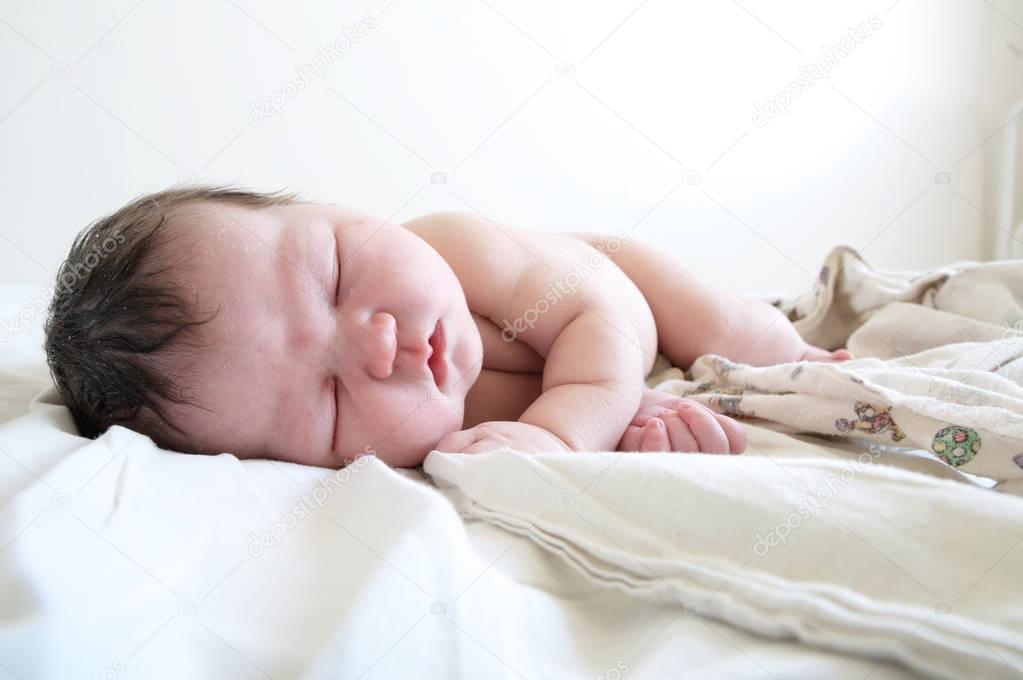 infant newborn baby first day life sleeping on diapers
