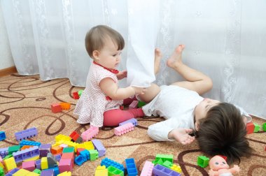 Oynayan iki küçük kız. Kız kardeşi - bebek ve toddler Oluşturucu oyuncaklar arasında