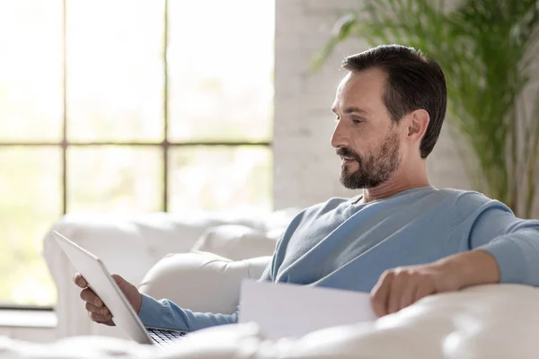 Hombre adulto serio mirando su computadora portátil — Foto de Stock