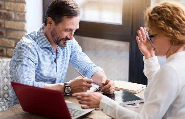 Medelålders par som arbetar på laptop och ta anteckningar — Stockfoto