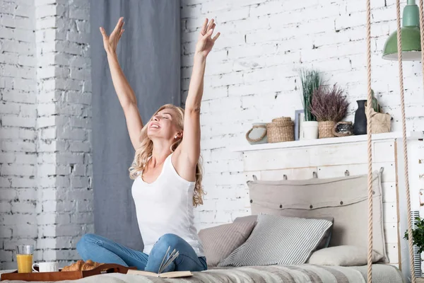 Blond lady is stretching on her bed in morning — Stock Photo, Image