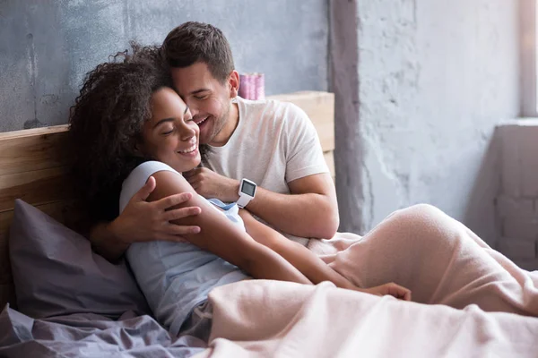 Par som omfamnar ömt i sin säng — Stockfoto