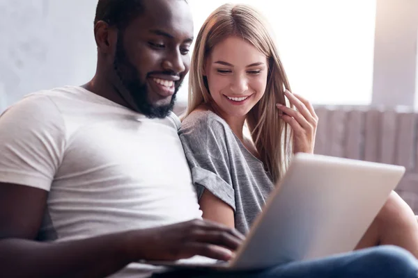 Laughing couple using laptop together — Stock Photo, Image