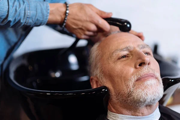 Old man during washing his hair in barber shop — Stock Photo, Image