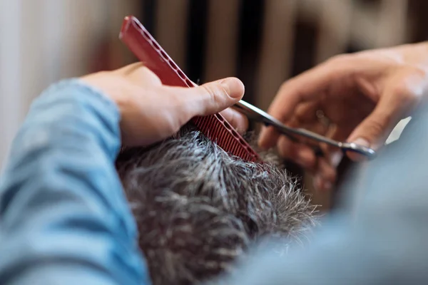 Gros plan du coiffeur pendant la coupe de cheveux pour homme aux cheveux gris — Photo