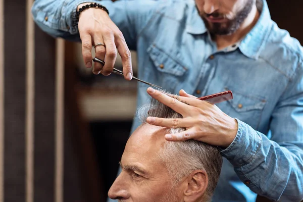 Closeup of senior man having haircut in barbershop — Stock Photo, Image