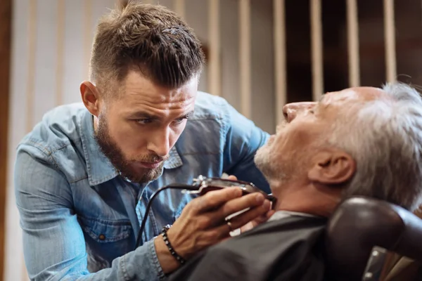 Nice male barber trimming neck of his client — Stock Photo, Image