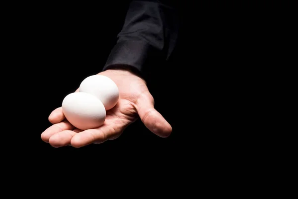 Close up of mans hand holding two eggs — Stock Photo, Image