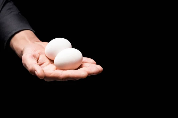 Close up of mans hand holding two eggs — Stock Photo, Image