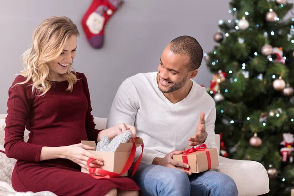 Cheerful nice couple opening their presents — Stock Photo, Image