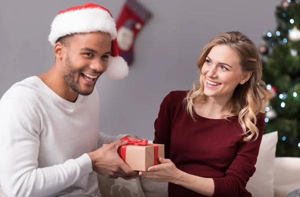 Happy charming woman giving a present — Stock Photo, Image