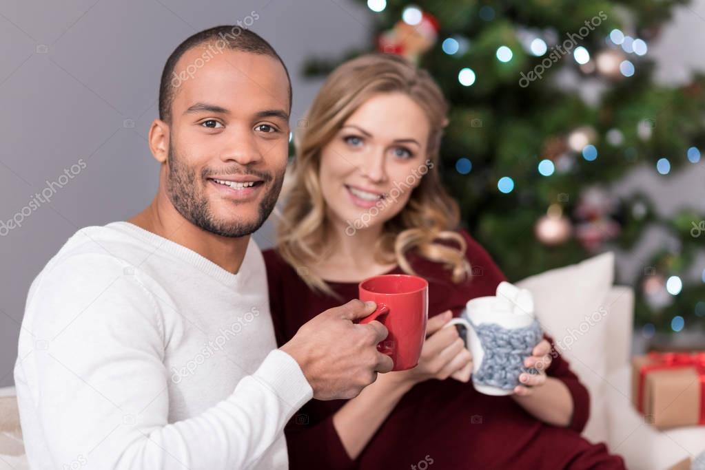 Pleasant positive man holding a red cup