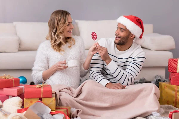 Nice caring man giving his wife a lollipop — Stock Photo, Image