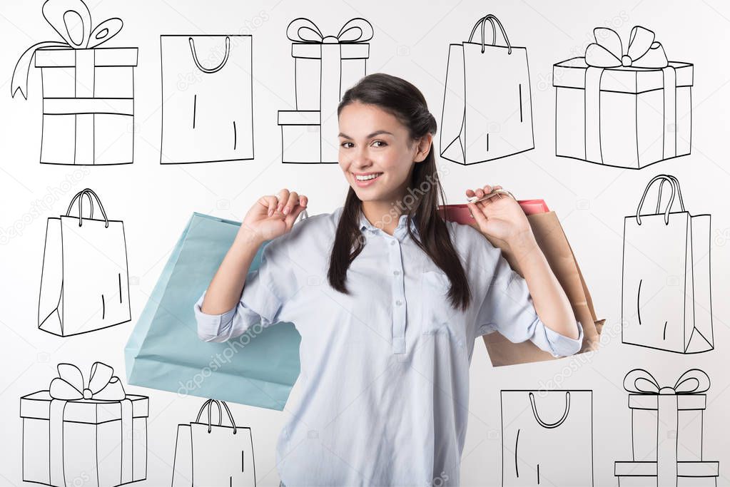 Beautiful woman holding packages after shopping