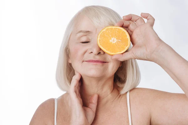 Woman holding  orange half — Stock Photo, Image
