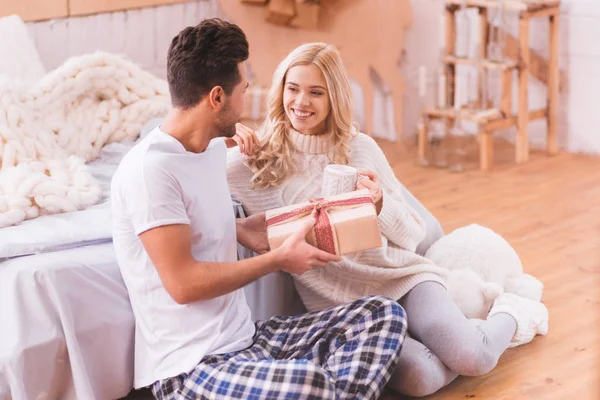 Pleasant nice man giving a gift to his girlfriend — Stock Photo, Image
