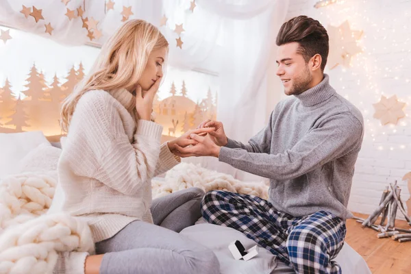 Cheerful pleasant man holding his girlfriends hands — Stock Photo, Image