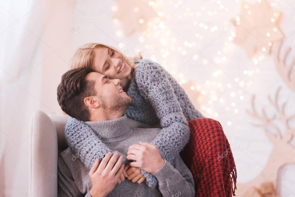 Beautiful happy woman hugging her boyfriend