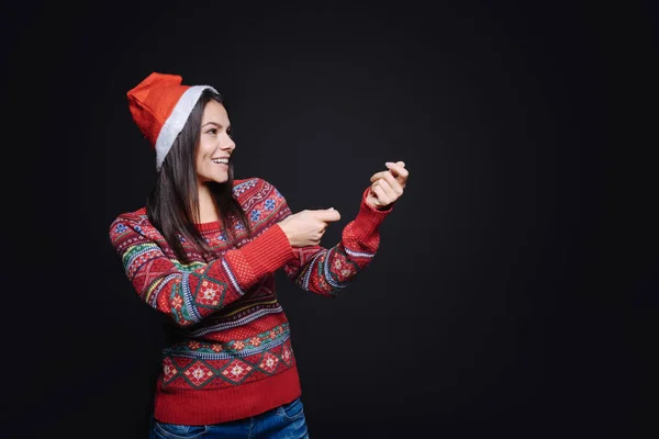 Amused girl holding an invisible petard — Stock Photo, Image