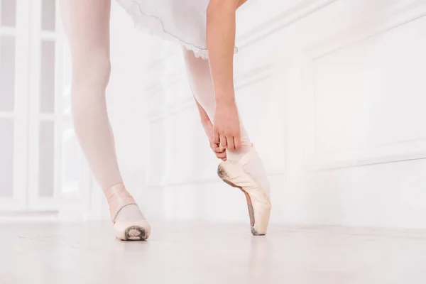 Close up of ballerina touching her ribbon — Stock Photo, Image